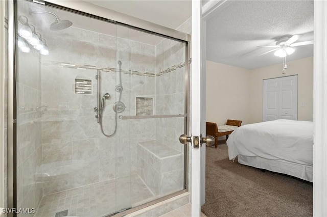 ensuite bathroom with a ceiling fan, a shower stall, ensuite bath, and a textured ceiling