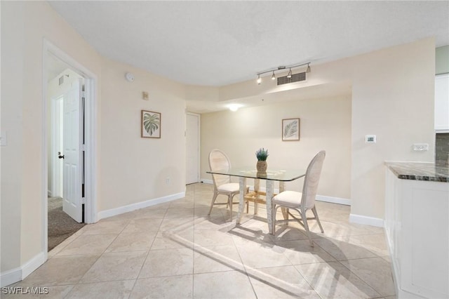 dining room with light tile patterned flooring, visible vents, and baseboards