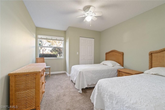 carpeted bedroom with ceiling fan and baseboards