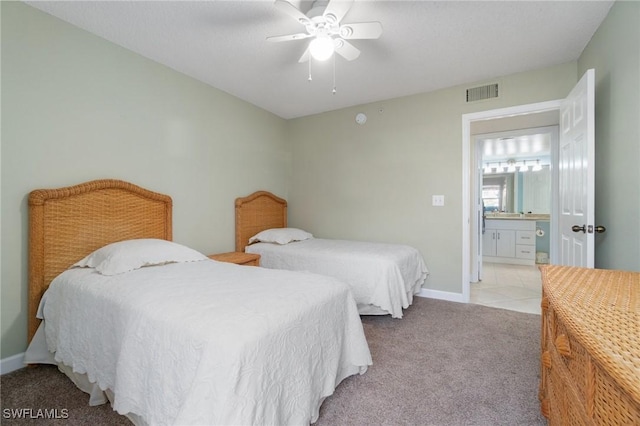 bedroom with light tile patterned floors, visible vents, light carpet, ceiling fan, and baseboards