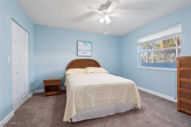 carpeted bedroom featuring a textured ceiling, ceiling fan, and baseboards