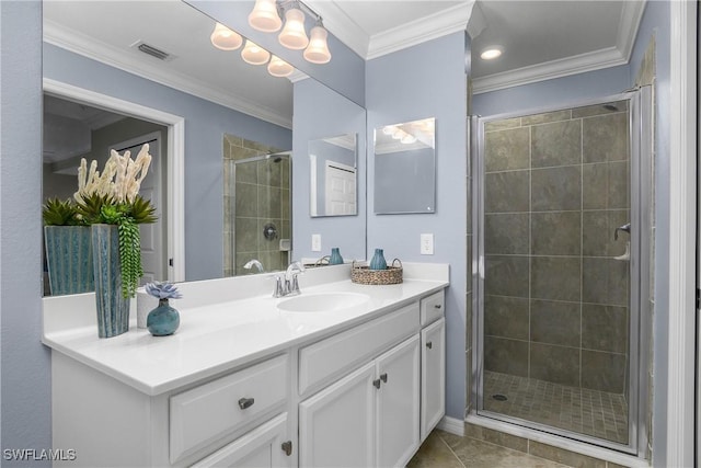 bathroom with tile patterned flooring, vanity, visible vents, a stall shower, and crown molding