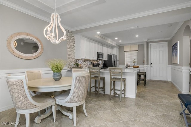 dining space featuring a wainscoted wall, light tile patterned floors, recessed lighting, and crown molding