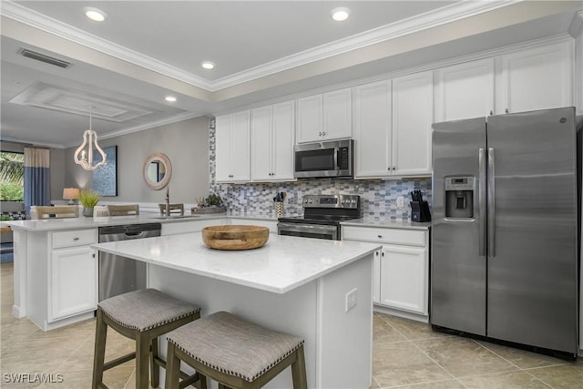 kitchen featuring crown molding, visible vents, appliances with stainless steel finishes, white cabinetry, and a peninsula