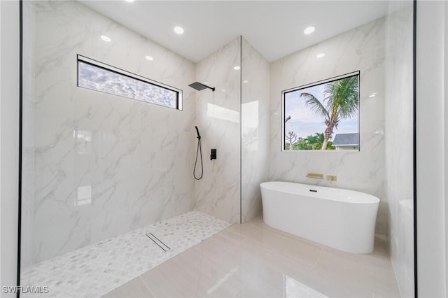 bathroom with recessed lighting, a freestanding tub, and a marble finish shower