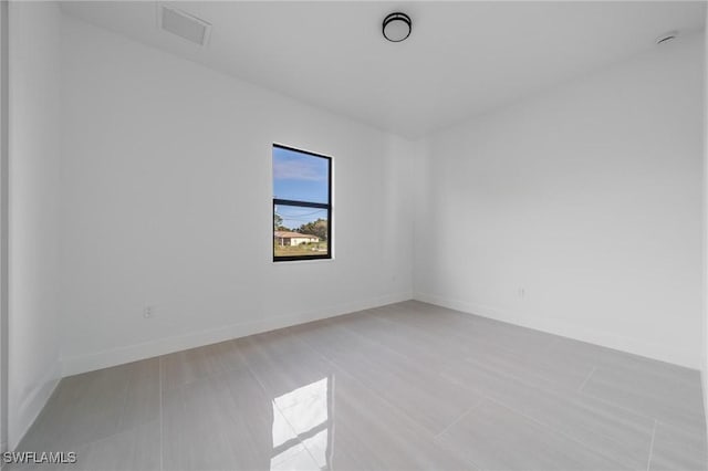 empty room with visible vents and baseboards