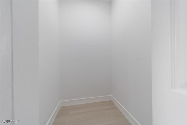 interior space featuring baseboards and wood finished floors