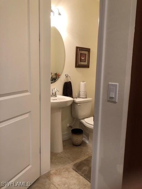 bathroom featuring toilet and tile patterned floors