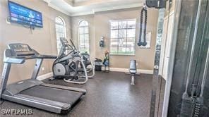 exercise room featuring baseboards and crown molding