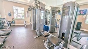 workout area featuring ornamental molding and baseboards