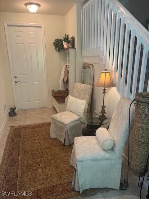 sitting room featuring light tile patterned floors and baseboards