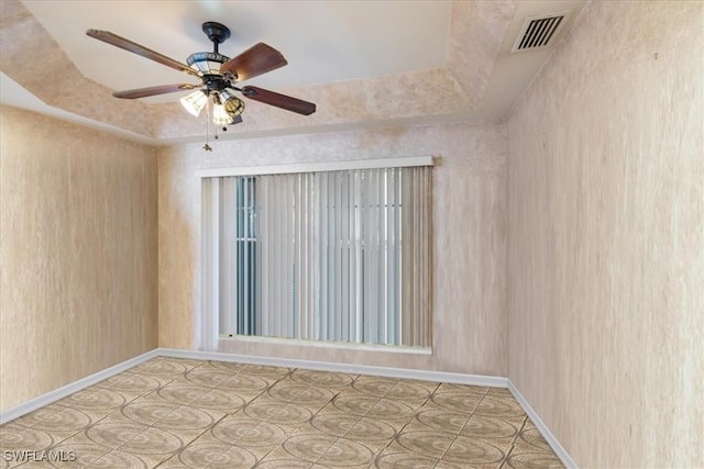 unfurnished room featuring visible vents and a ceiling fan