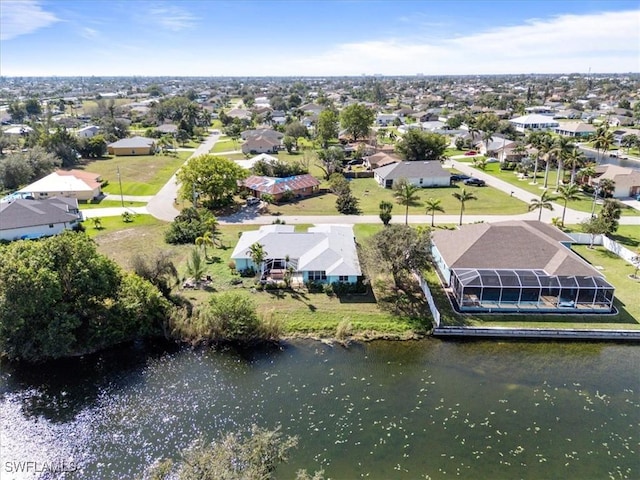 drone / aerial view with a water view and a residential view