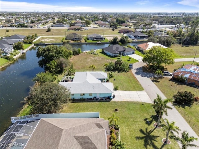 bird's eye view featuring a water view and a residential view