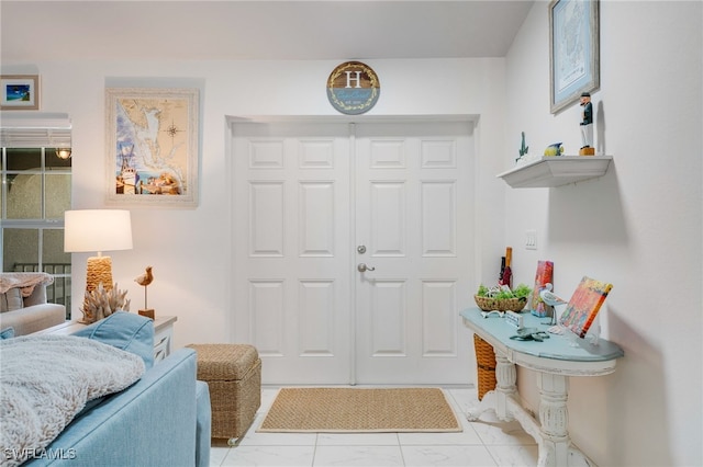 entryway featuring marble finish floor