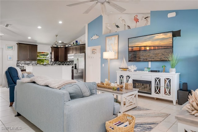 living area with lofted ceiling, visible vents, a ceiling fan, and recessed lighting