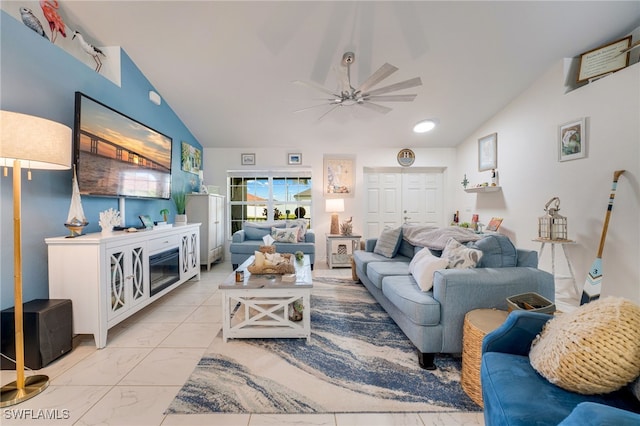 living room featuring lofted ceiling, marble finish floor, and a ceiling fan