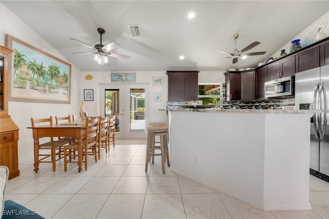 kitchen with french doors, marble finish floor, lofted ceiling, visible vents, and appliances with stainless steel finishes