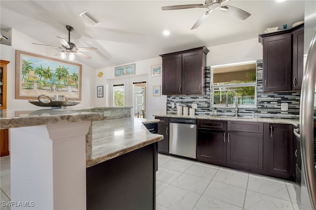 kitchen with marble finish floor, stainless steel appliances, visible vents, decorative backsplash, and a sink