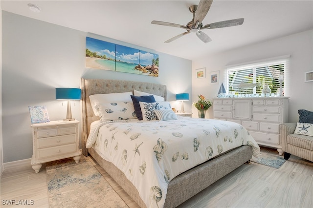 bedroom featuring light wood-style floors, ceiling fan, and baseboards