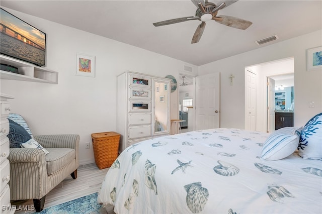 bedroom with visible vents, ceiling fan, and wood finished floors