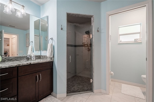 full bath with a stall shower, marble finish floor, baseboards, and toilet