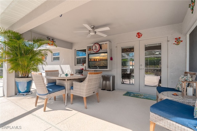 view of patio with a ceiling fan, french doors, and outdoor dining area