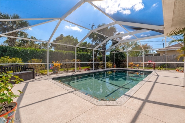 view of pool featuring a patio, fence, a fenced in pool, and a lanai