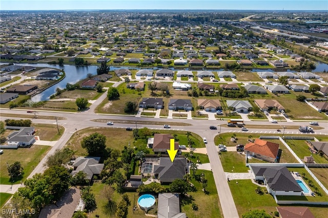 drone / aerial view featuring a residential view and a water view