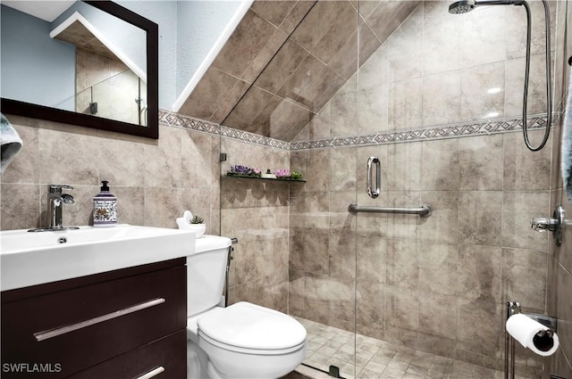 bathroom with toilet, a stall shower, and vanity