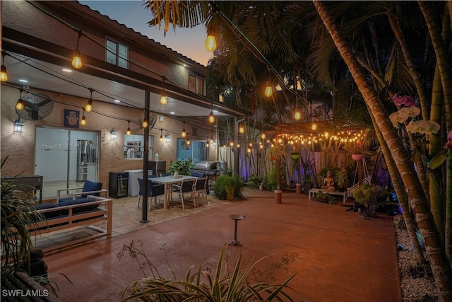 view of patio featuring fence and a grill