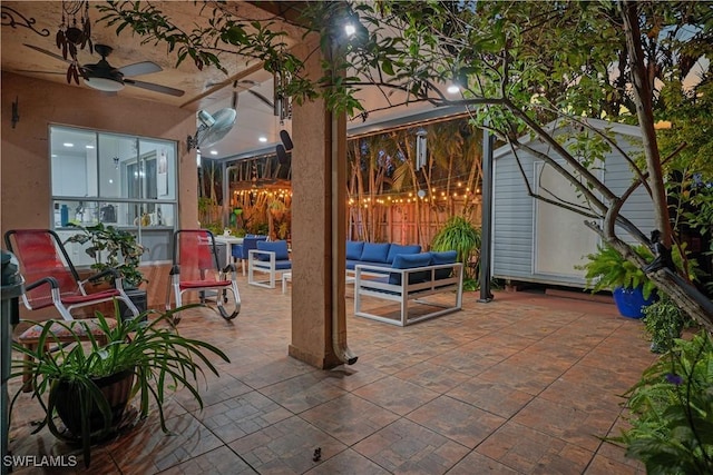 view of patio / terrace featuring ceiling fan, fence, and an outdoor living space