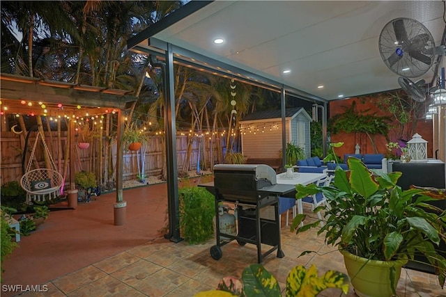 view of patio with an outbuilding, a fenced backyard, outdoor dining space, and a shed