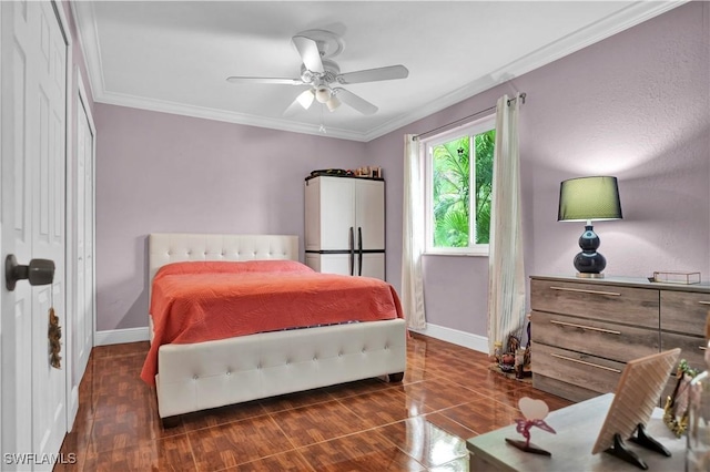 bedroom featuring a ceiling fan, crown molding, and baseboards