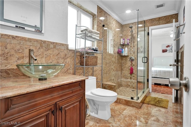 full bath featuring a stall shower, visible vents, crown molding, vanity, and tile walls