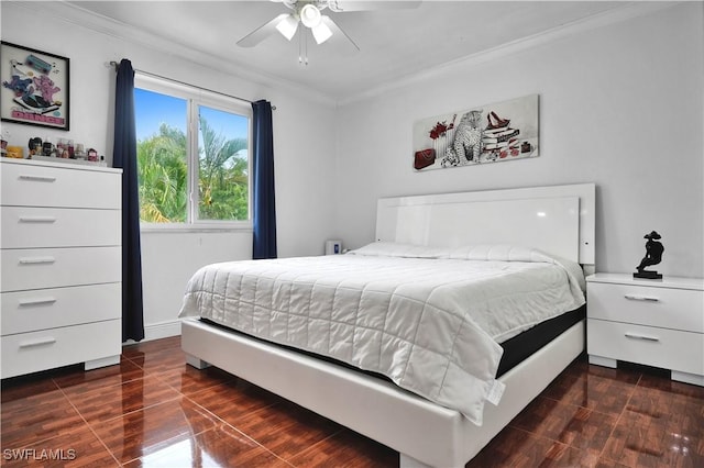 bedroom featuring ornamental molding, dark wood-style flooring, and ceiling fan