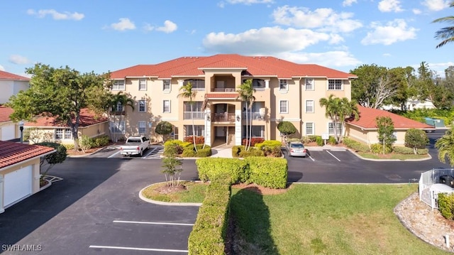 view of property featuring uncovered parking and a residential view