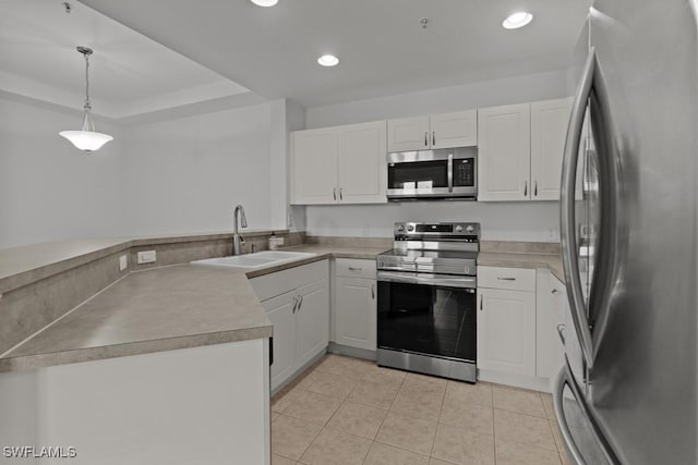 kitchen with stainless steel appliances, white cabinets, hanging light fixtures, and a sink