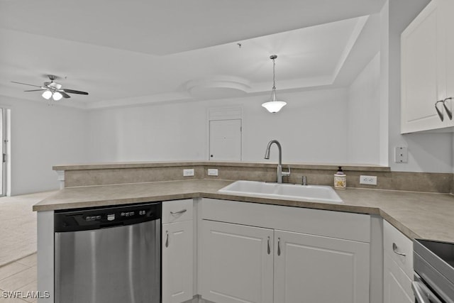 kitchen with white cabinets, dishwasher, hanging light fixtures, light countertops, and a sink