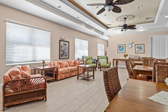 living room with visible vents, a raised ceiling, crown molding, and recessed lighting