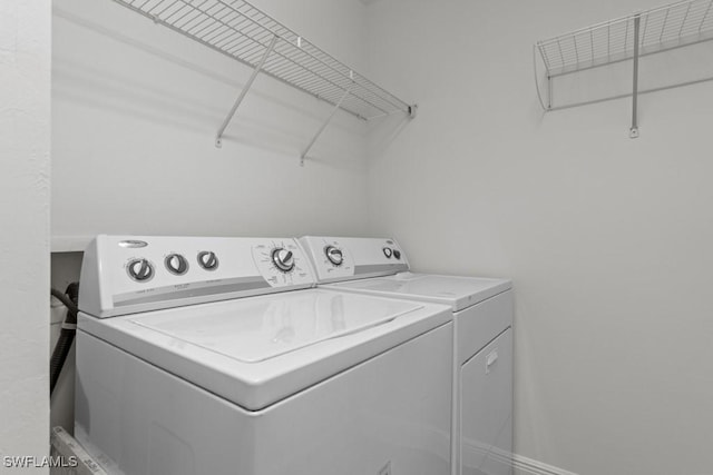 washroom featuring laundry area and washer and clothes dryer