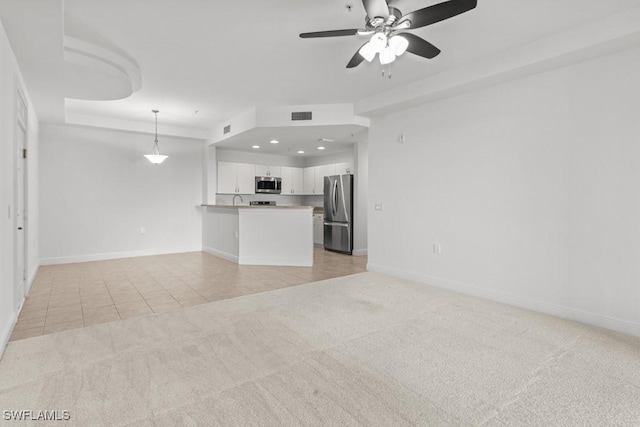 unfurnished living room featuring light carpet, light tile patterned floors, baseboards, and visible vents