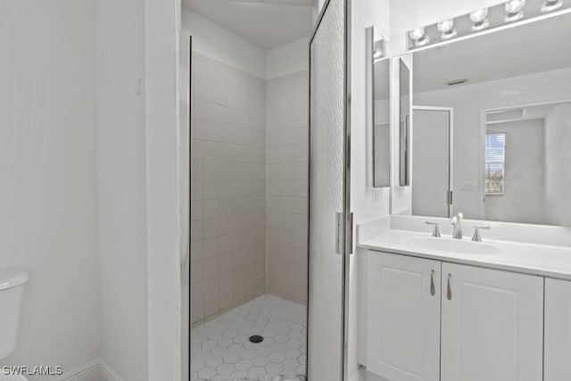 full bathroom with toilet, a shower stall, and vanity