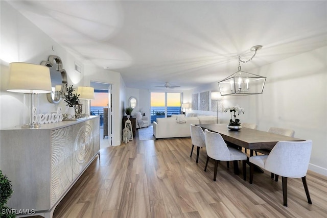 780 S Collier Blvd Unit 708, Marco Island, FL 34145 - dining space with visible vents, light wood finished floors, and ceiling fan with notable chandelier