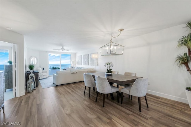 780 S Collier Blvd Unit 708, Marco Island, FL 34145 - dining area featuring wood finished floors, baseboards, and ceiling fan with notable chandelier