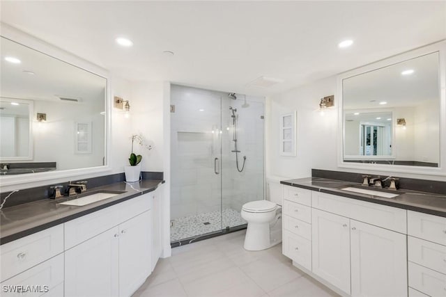 780 S Collier Blvd Unit 708, Marco Island, FL 34145 - full bathroom featuring two vanities, toilet, a sink, and a stall shower