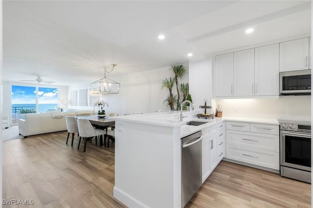 780 S Collier Blvd Unit 708, Marco Island, FL 34145 - kitchen with a sink, open floor plan, stainless steel appliances, a peninsula, and recessed lighting