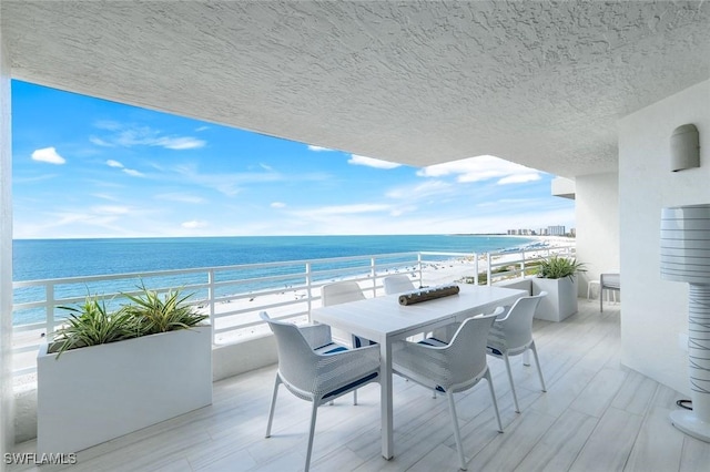 780 S Collier Blvd Unit 708, Marco Island, FL 34145 - balcony featuring a view of the beach, outdoor dining space, and a water view