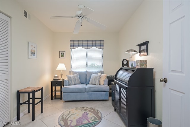 living room with visible vents, ceiling fan, baseboards, and light tile patterned floors