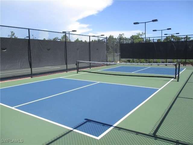 view of sport court featuring community basketball court and fence